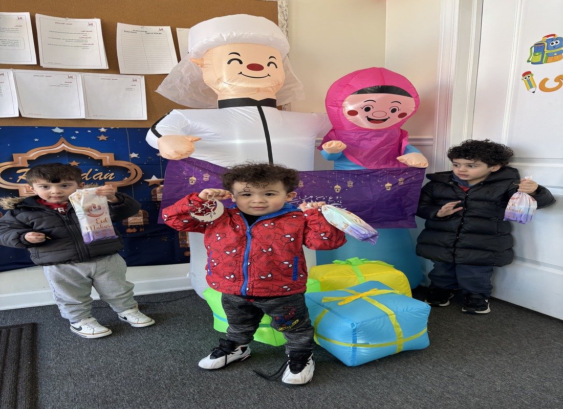Young students celebrating Eid with goody bags and festive decorations at Iqra Learning