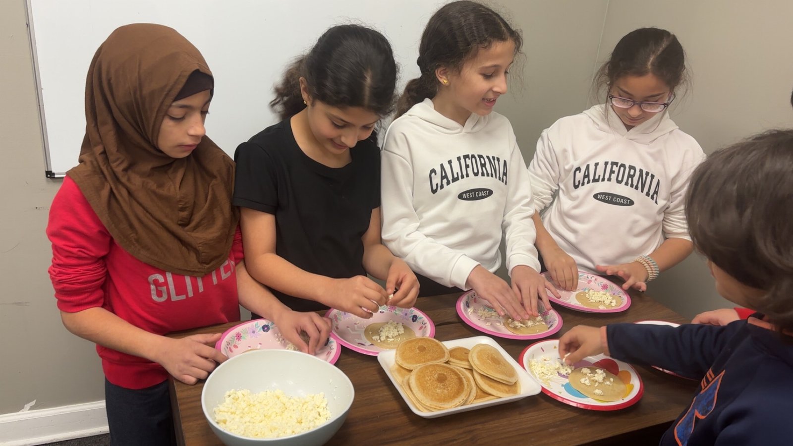 Students preparing katayef, a traditional Arabic dessert, during a fun cooking activity at Iqra Learning